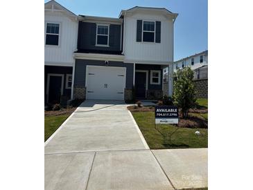Charming two-story home with a one-car garage and well-maintained front lawn at 4216 Summit Woods Dr, Charlotte, NC 28216