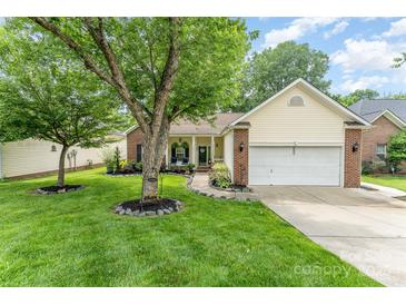 Charming home featuring brick accents, a well-manicured lawn, and a tree-shaded front yard at 5829 Andrew Ward Ave, Charlotte, NC 28216