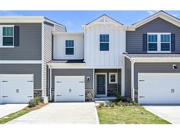 Charming townhouse featuring gray siding, a one-car garage, and a welcoming front entrance at 6110 Starview Ter, Charlotte, NC 28216