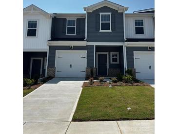 Charming new construction townhome featuring a one-car garage and beautifully landscaped front yard at 6118 Starview Ter, Charlotte, NC 28216