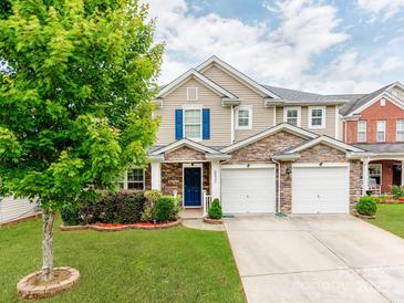 Charming two-story home with a stone facade and a well-manicured front yard at 6532 Prosperity Commons Dr, Charlotte, NC 28269