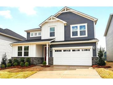 Beautiful two-story home with a two car garage, landscaped yard, and stone accents at 9930 Cask Way, Huntersville, NC 28078