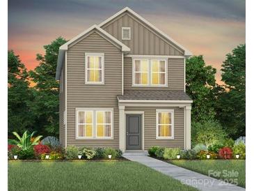 Charming two-story home featuring neutral siding, and a welcoming front yard with manicured landscaping at 14028 Penbury Ln # 331, Charlotte, NC 28278
