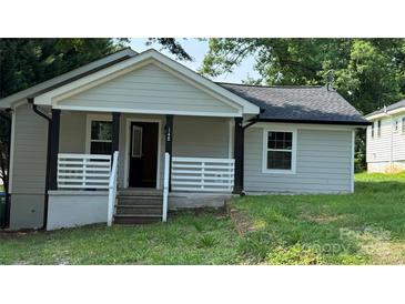 Charming front of house featuring a cozy porch with black posts and white railings at 148 Forest Heights Dr, Mcadenville, NC 28101