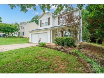 Charming two-story home featuring a well-manicured lawn and attached two car garage at 1912 8Th Se St, Hickory, NC 28602