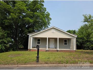 Charming single-story home with gray siding, a welcoming front porch, and a well-maintained lawn at 38 Holly St, Great Falls, SC 29055