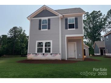 New construction two-story home features gray siding, black shutters, and a covered front porch, blending modern design with classic charm at 4040 Grommet Ct, Matthews, NC 28105