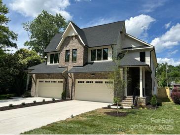 Stunning two-story home featuring a brick and siding exterior, two-car garage, and well-manicured landscaping at 514 W Cama St, Charlotte, NC 28217