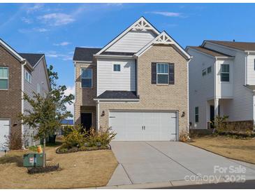 Charming two-story home with a brick and siding facade, attached garage, and well-manicured lawn at 518 Palmarosa St, Fort Mill, SC 29715