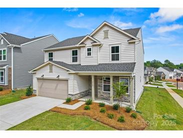 Charming two-story home featuring stone accents, attached garage, and landscaped front yard at 5236 Hatcher Creek Rd # 52, Charlotte, NC 28215