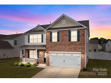 Charming two-story brick home with a manicured lawn and attached two-car garage, perfect for suburban living at 7172 Teague Dr, Gastonia, NC 28056