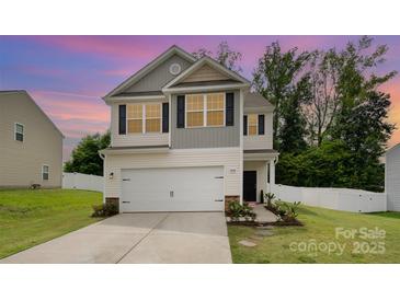 Charming two-story home with a two-car garage, landscaped yard, and a welcoming entrance at 7209 Cuddington Dr, Charlotte, NC 28215