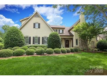 Charming exterior elevation of home with manicured landscaping and mature trees, providing a warm and inviting curb appeal at 1103 Mapesbury Ln, Waxhaw, NC 28173
