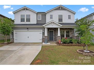 Charming two-story home with a two-car garage and stone veneer accents at 12536 Stoneybrook Pkwy, Huntersville, NC 28078