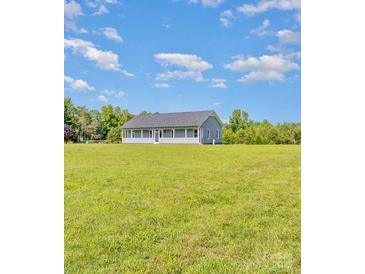 Exterior of a one-story home with a long porch and a large lawn at 135 Waycross Dr, Rockwell, NC 28110