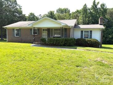 Charming single-story home with a well-maintained lawn and mature trees at 1460 Legion Rd, Fort Mill, SC 29715