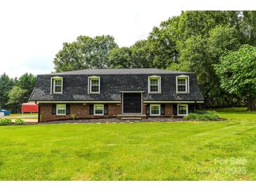 Charming home featuring a landscaped front yard and a classic mansard roof design at 1867 Shannon Dr, Conover, NC 28613