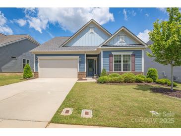 Charming single-Gathering home with well-maintained lawn and a two-car garage in a suburban neighborhood at 215 Pintail Dr, Monroe, NC 28110