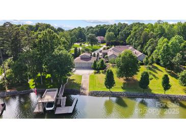 Waterfront property with boat dock on a well manicured lot with mature trees in a peaceful setting at 2354 Valelake Rd, York, SC 29745