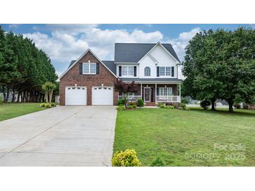 Charming two-story brick home with a well-manicured lawn and two-car garage at 2779 Touchstone Cir, Newton, NC 28658