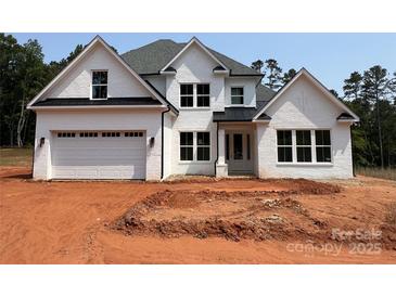 Charming two-story home featuring a white brick facade and a spacious two-car garage at 4622 Serenity Woods Ct, Charlotte, NC 28216
