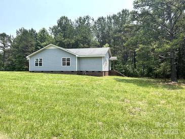 Charming single-story home with light blue siding and well-maintained lawn at 5410 A R Gordon Rd, Waxhaw, NC 28173
