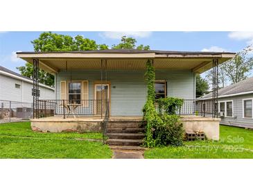Charming home featuring a cozy front porch with decorative railings, perfect for relaxing outdoors at 92 E Spencer Mountain Ave, Gastonia, NC 28054