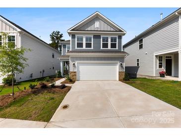 Charming two-story home with a two-car garage and nicely landscaped front yard at 15208 Caspian Way, Charlotte, NC 28278