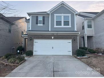 Charming two-story home with a two-car garage and beautiful light-blue siding at 15524 Scholastic Dr, Charlotte, NC 28277