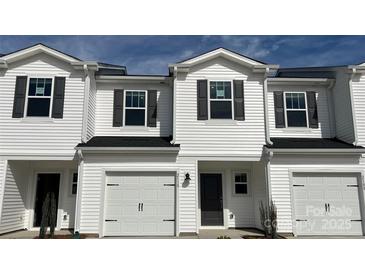 Charming townhome with white siding, black shutters, and a one-car garage, showcasing modern curb appeal at 1750 Old Rivers Rd, Concord, NC 28027