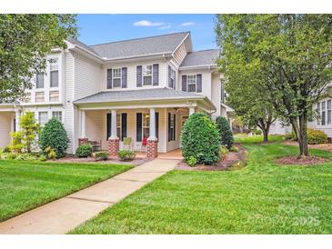 Charming two-story home with black shutters, a covered porch, and a well-manicured lawn at 2065 Gable Way Ln, Matthews, NC 28104