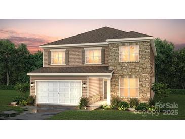 Charming two-story home featuring a mix of stone and shingle siding and a two-car garage at 21055 Running Creek Dr # 10, Locust, NC 28097