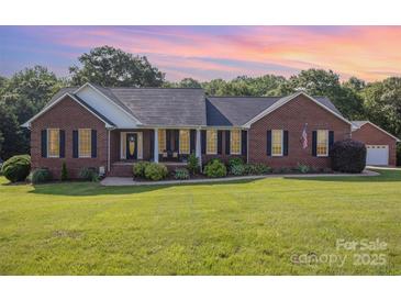 Charming one-story brick home with black shutters, manicured lawn, and an inviting front porch at 214 Silver Creek Ln, Shelby, NC 28152