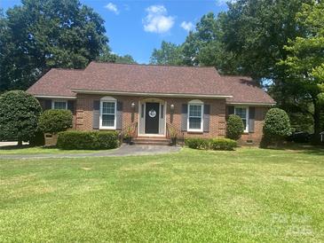 Charming brick ranch-style home featuring a lush green lawn and beautifully manicured landscaping, located on a tree-lined street at 2592 Tully Ct # 78, Lancaster, SC 29720