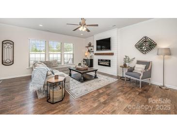 Comfortable living room featuring a modern fireplace, large sectional sofa, and stylish decor at 4012 Woodsmill Rd, Fort Mill, SC 29707