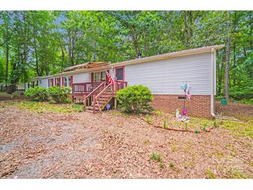 Charming single-story home with front porch and mature trees, nestled on a wooded lot at 6010 Old Pageland Marshville Rd, Marshville, NC 28103