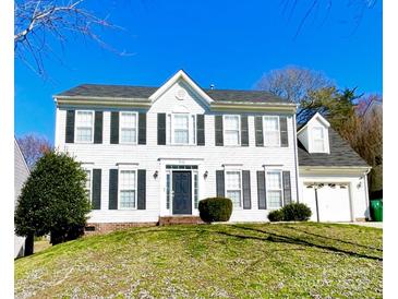 Charming two-story home with black shutters, a manicured lawn, and an attached two-car garage at 9146 Austin Ridge Ln, Charlotte, NC 28214