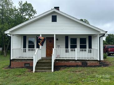 Charming home with a covered front porch, white siding, and black shutters at 200 Prospect Church Rd, Albemarle, NC 28001