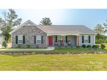Charming single-story home featuring stone accents, a welcoming front porch, and a well-maintained front yard at 2737 Bobcat Rd, Heath Springs, SC 29058