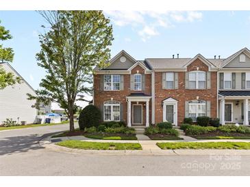 Charming brick townhome featuring a well-manicured lawn and tasteful landscaping, offering curb appeal at 4208 Coulter Xing, Charlotte, NC 28213