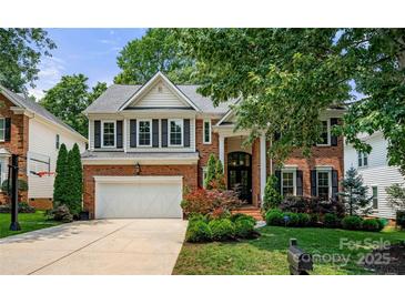 Stately two-story brick home with a landscaped front yard, driveway, and a two car garage at 8500 Headford Rd, Charlotte, NC 28277