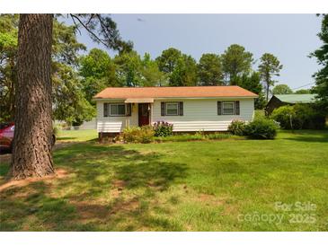 Charming single-story home featuring a well-maintained lawn and mature trees at 252 Chuckwood Rd, Mooresville, NC 28117