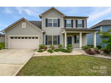 Charming two-story home with a well-manicured lawn, attached two-car garage, and inviting front porch at 3486 Duchess Ave, Fort Mill, SC 29707