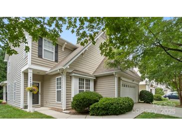 Charming home with tan siding, green bushes, and a well-maintained front yard at 424 Paperbark Ln, Rock Hill, SC 29732
