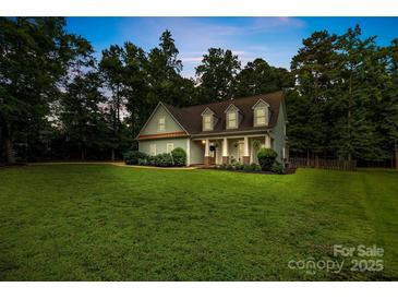 Charming home with a sprawling front lawn and a welcoming front porch framed by stately columns at 481 Evergreen Rd, Clover, SC 29710