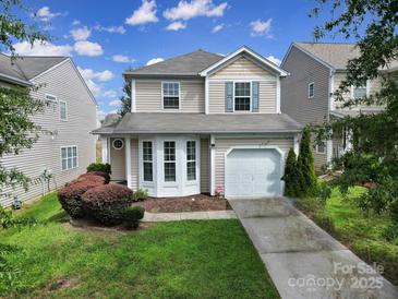 Charming two-story home with a well-manicured lawn, inviting entrance, and attached one car garage at 920 Old Forester Ln, Charlotte, NC 28214