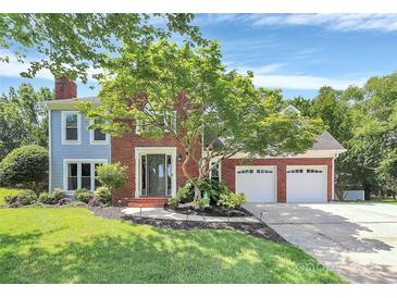 Charming two-story home with a brick facade, attached two-car garage, and a well-maintained lawn at 1011 Bydeford Ct, Matthews, NC 28105