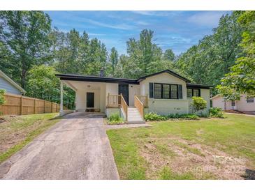 Charming single-story home with covered parking, a well-maintained lawn, and inviting front entrance at 1214 Northwoods Dr, Kings Mountain, NC 28086