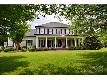 Charming two-story home with inviting front porch and manicured lawn at 19625 Callaway Hills Ln, Davidson, NC 28036