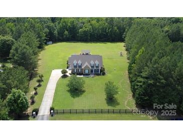 Expansive aerial view of a stately home with lush green lawn, mature trees, and long private driveway at 2018 Whiskery Ct, York, SC 29745